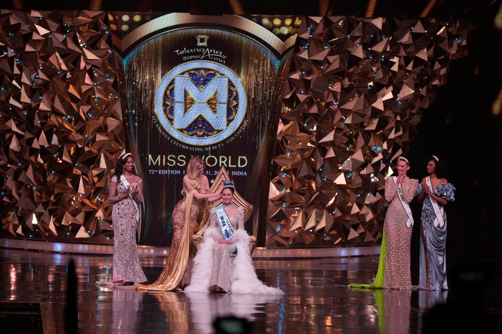 Krystyna Pyszkova of Czech Republic, crowns her successor Opal Suchata of Thailand after she who won the 72nd Miss World pageant in Hyderabad, India, Saturday, May 31, 2025. (AP Photo/Mahesh Kumar A.)