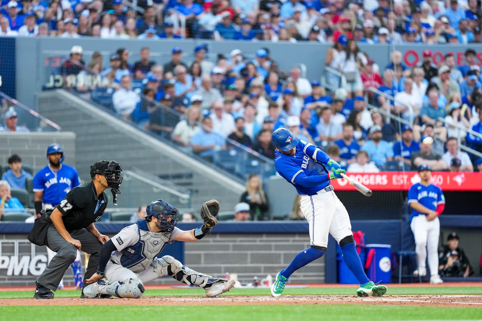 Toronto Blue Jays' George Springer (4) hits a two-run home run against the New York Yankees during third inning MLB baseball action, in Toronto on Thursday, July 3, 2025. (Thomas Skrlj/The Canadian Press via AP)