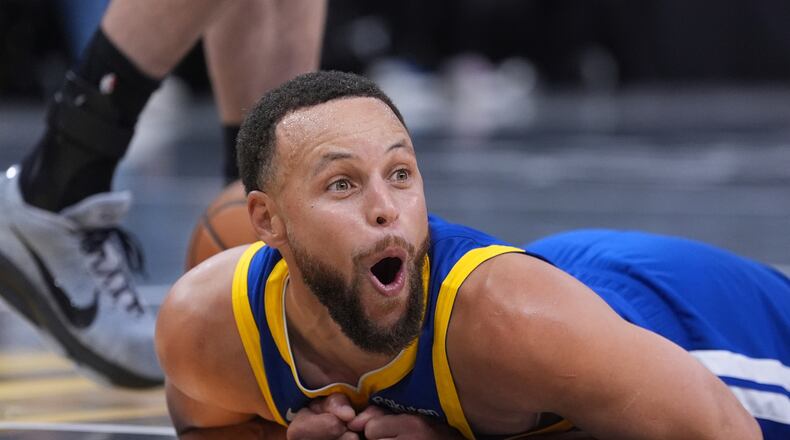 Golden State Warriors guard Stephen Curry (30) reacts after he was fouled during the second half of an NBA Cup basketball game against the San Antonio Spurs in San Antonio, Friday, Nov. 14, 2025. (AP Photo/Eric Gay)
