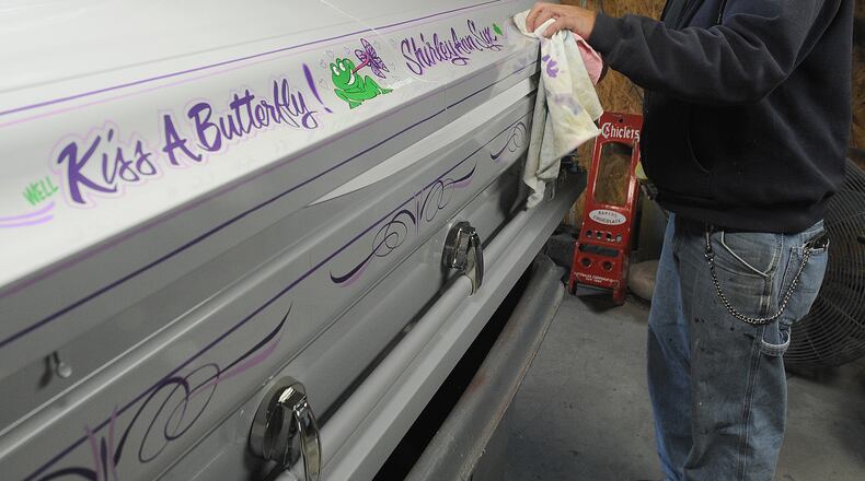 Fairborn sign painter and pinstriper Shane Syx pays homage to his late mother, Shirley Ann Syx, by adding his artwork to her casket. Syx has done eight caskets, including his father’s, and several urns. The frog represents his father, the butterfly his mother, and the little butterflies his brothers and sisters.
