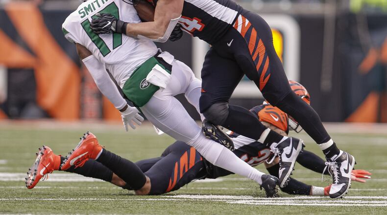 CINCINNATI, OH - DECEMBER 01: Sam Hubbard #94 of the Cincinnati Bengals makes the hit on Vyncint Smith #17 of the New York Jets during the first half at Paul Brown Stadium on December 1, 2019 in Cincinnati, Ohio. (Photo by Michael Hickey/Getty Images)