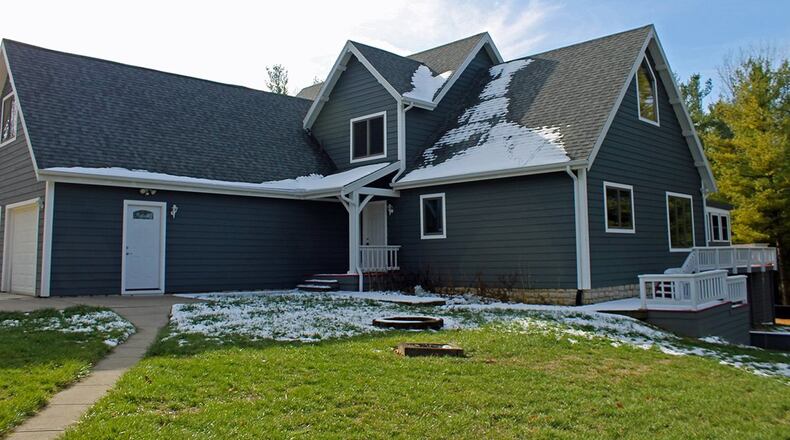 This 3-bedroom home features an open interior with about 3,140 sq. ft. of living space. The property includes an attached, 2-car garage, outbuilding and deck. CONTRIBUTED PHOTO BY VICKIE KAPNAS
