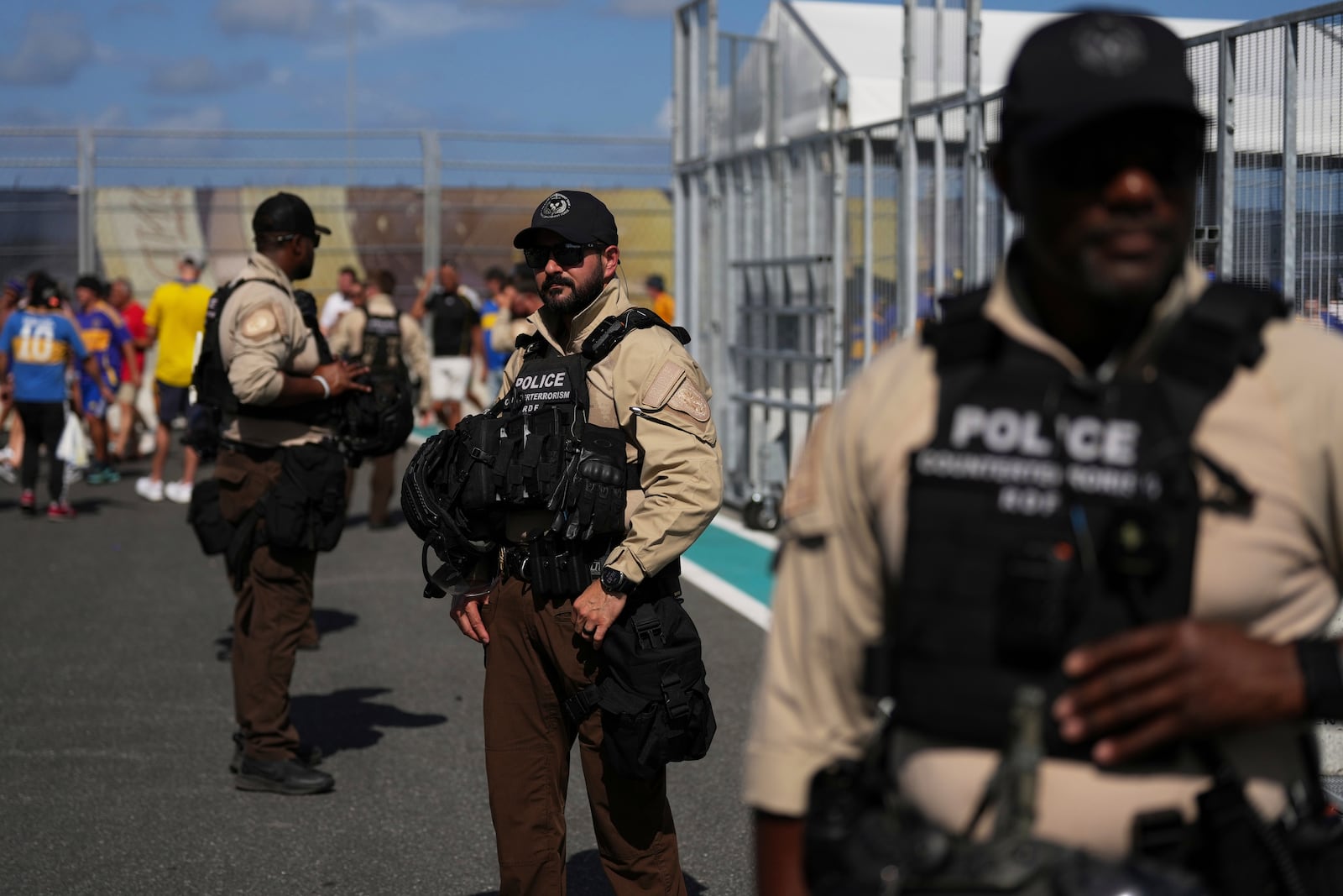 Law enforcement personnel stand outside the stadium prior to the Club World Cup group C soccer match between Boca Juniors and Benfica in Miami Gardens, Fla., Monday, June 16, 2025. (AP Photo/Rebecca Blackwell)