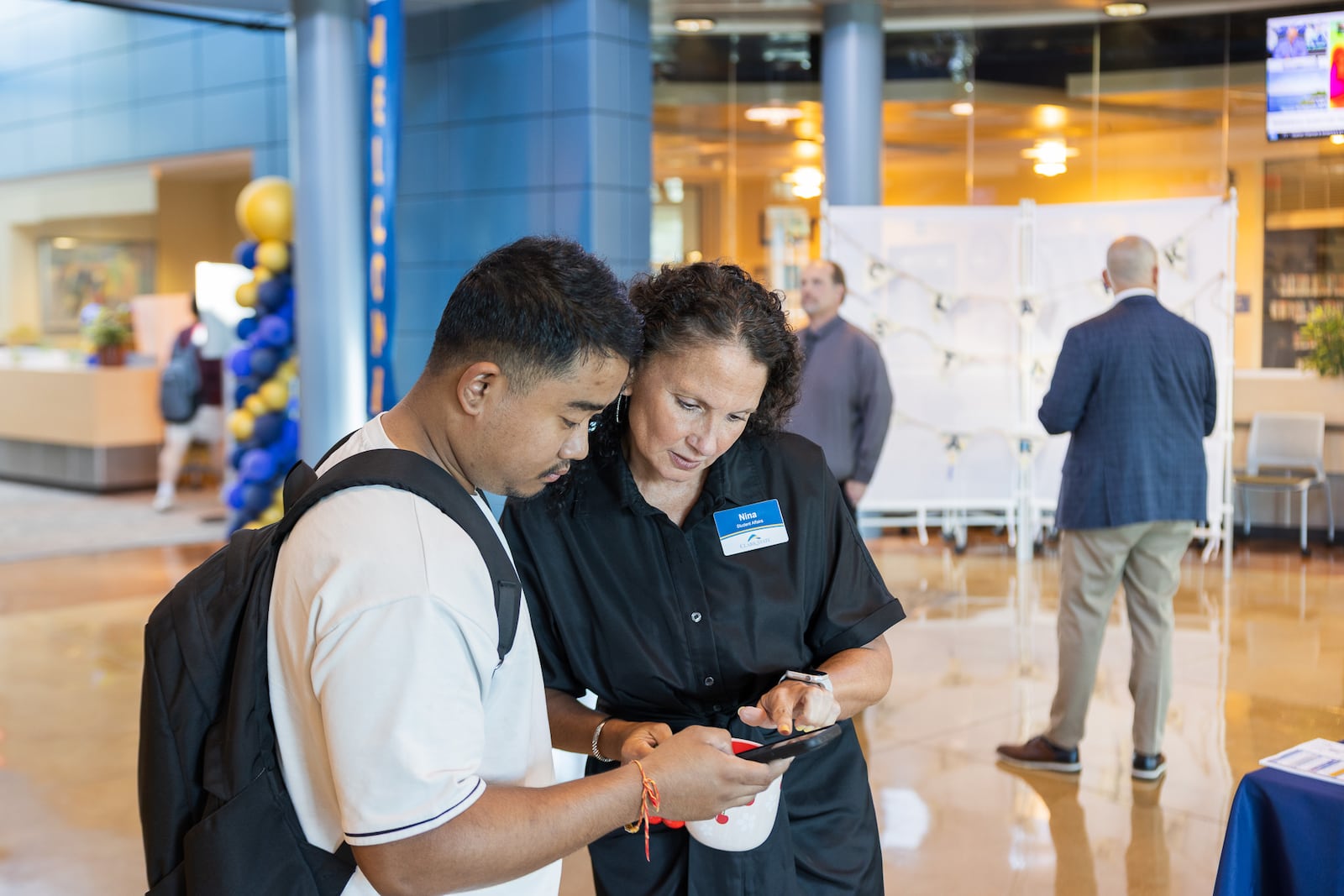 Nina Wiley, assistant vice president of student affairs, helps Navin Waiba, an international registered nursing student from Nepal, review his schedule. CONTRIBUTED