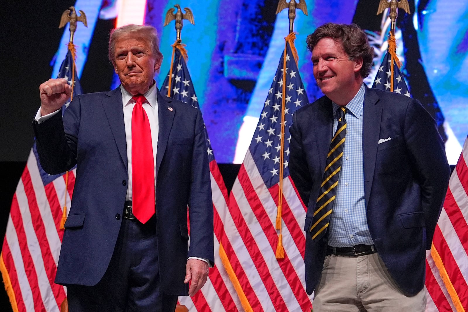 FILE - Republican presidential nominee former President Donald Trump speaks with Tucker Carlson during a Tucker Carlson Live Tour show at Desert Diamond Arena, Oct. 31, 2024, in Glendale, Ariz. (AP Photo/Julia Demaree Nikhinson, File)