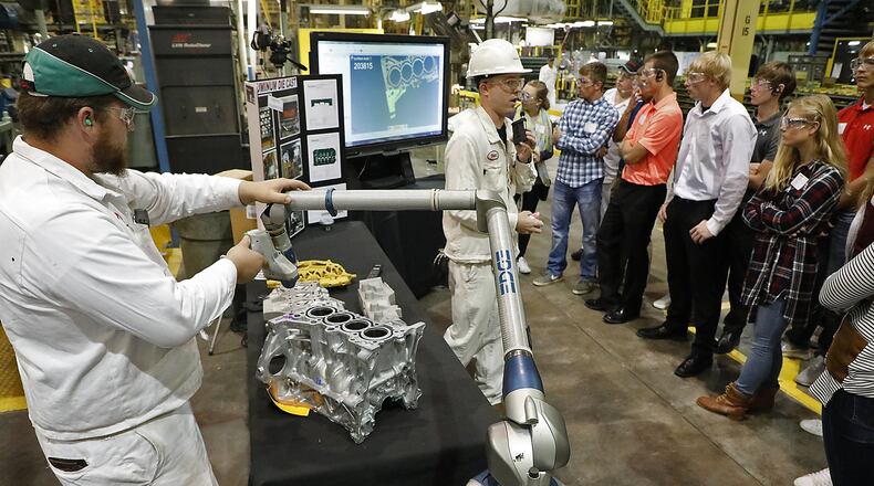 Honda associates, at the Honda engine plant in Anna, talk to a group of high school students about the tools they use in the aluminum casting department of the plant during the Honda Manufacturing Day on Oct. 5. 2017. The programs are paying off as more young people are entering manufacturing, Champaign County leaders say. Bill Lackey/Staff