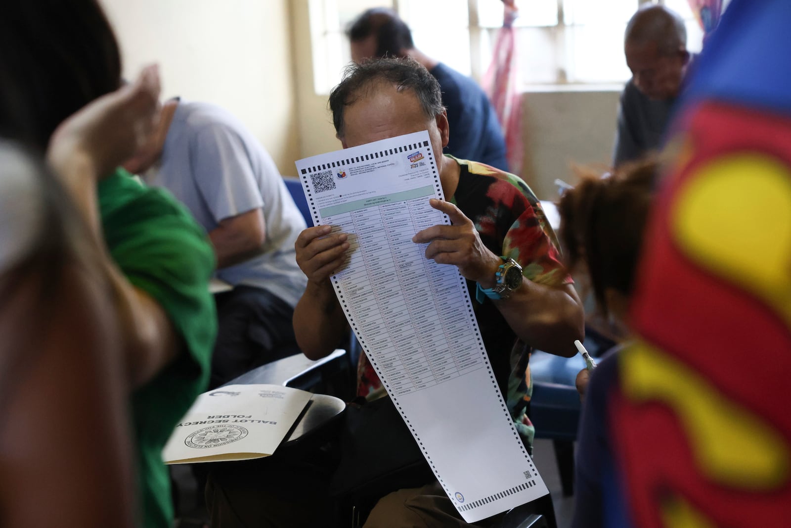 A man casts his ballot at a polling station in Quezon City, Philippines, Monday, May 12, 2025. (AP Photo/Basilio Sepe)