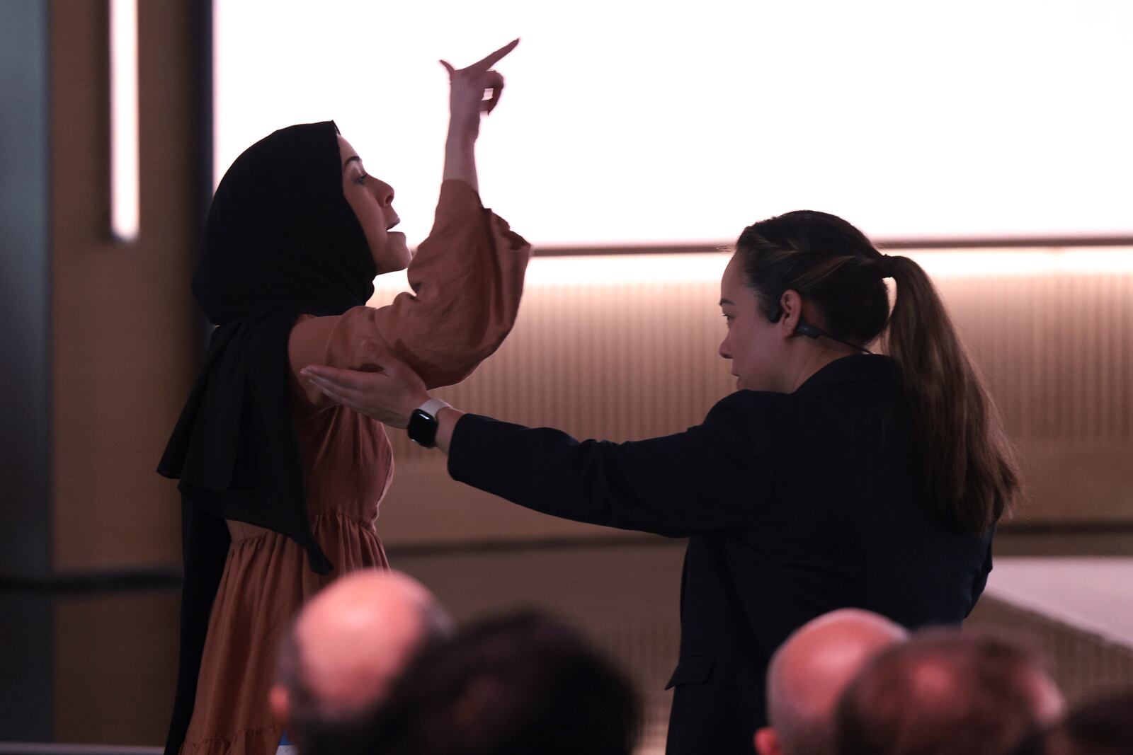 A pro-Palestinian demonstrator is escorted away by security as they interrupt Microsoft AI CEO Mustafa Suleyman during a presentation of the company's AI assistant, Copilot, ahead of a 50th Anniversary presentation at Microsoft headquarters, Thursday, March 14, 2024, in Redmond, Wash. (AP Photo/Jason Redmond)