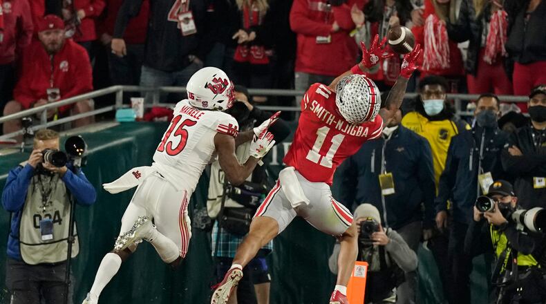 Ohio State wide receiver Jaxon Smith-Njigba (11) catches a touchdown in front of Utah cornerback Malone Mataele (15) during the second half in the Rose Bowl NCAA college football game Saturday, Jan. 1, 2022, in Pasadena, Calif. (AP Photo/Mark J. Terrill)