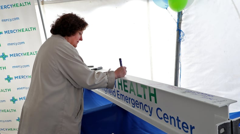 Cheryl Haines signs a ceremonial steel beam during the ground breaking ceremony in October for the new Mercy Health Dayton-Springfield Emergency Center.