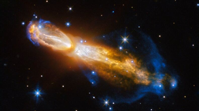 The Calabash Nebula, pictured here- which has the technical name OH 231.8+04.2 - is a spectacular example of the death of a low-mass star like the Sun. This image taken by the NASA/ESA Hubble Space Telescope shows the star going through a rapid transformation from a red giant to a planetary nebula, during which it blows its outer layers of gas and dust out into the surrounding space. The recently ejected material is spat out in opposite directions with immense speed , the gas shown in yellow is moving close to a million kilometres an hour. Astronomers rarely capture a star in this phase of its evolution because it occurs within the blink of an eye  in astronomical terms. Over the next thousand years the nebula is expected to evolve into a fully fledged planetary nebula. The nebula is also known as the Rotten Egg Nebula because it contains a lot of sulphur, an element that, when combined with other elements, smells like a rotten egg  but luckily, it resides over 5000 light-years away in the constellation of Puppis (The Poop deck).