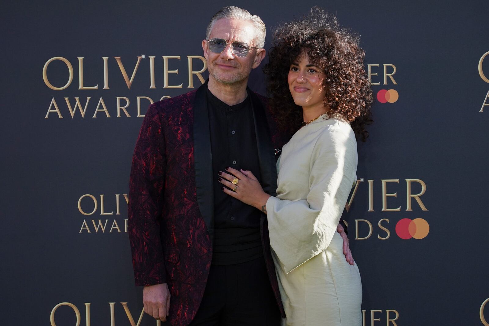 Martin Freeman and Rachel Mariam pose for photographers upon arrival at the Olivier Awards on Sunday, April 6, 2025, in London. (Photo by Alberto Pezzali/Invision/AP)