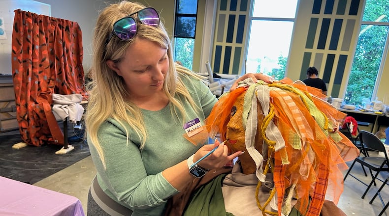 Melinda Montgomery works on her family's version of the famous Mona Lisa painting that will be part of the annual Project Scare-a-Crow display in National Road Commons Park that will go up on Friday, Oct. 3. The 2025 theme is Iconic Works of Art. They will be on display during ChalkFest in the park on Saturday, Oct. 4 and through Oct. 24. CONTRIBUTED
