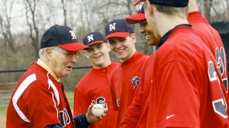 Former North baseball coach Don Henderson shakes hands with the current players after throwing out a ceremonial first pitch to his former player, North assistant Doug Stoll, before North played Northwestern in the Panther Classic Saturday, April 12, 2008. Staff Photo by Barbara J. Perenic
