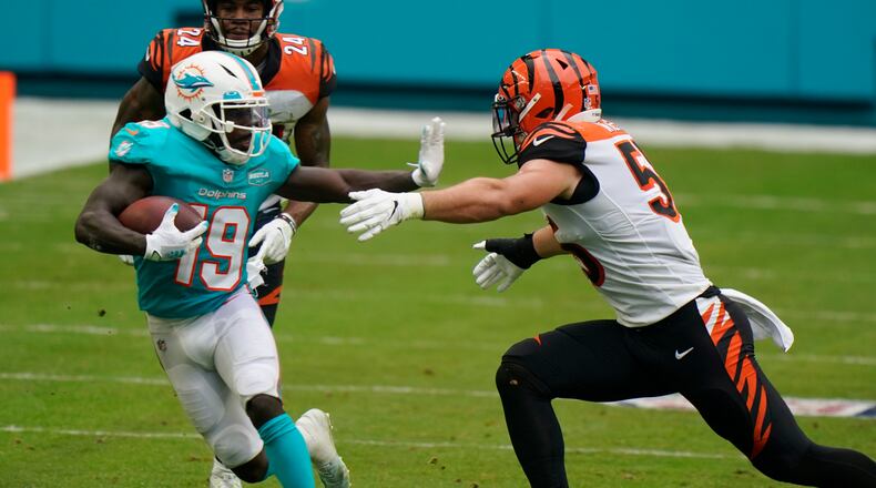Miami Dolphins wide receiver Jakeem Grant (19) runs the football as Cincinnati Bengals linebacker Logan Wilson (55) attempts to tackle during the second half of an NFL football game, Sunday, Dec. 6, 2020, in Miami Gardens, Fla. (AP Photo/Wilfredo Lee)