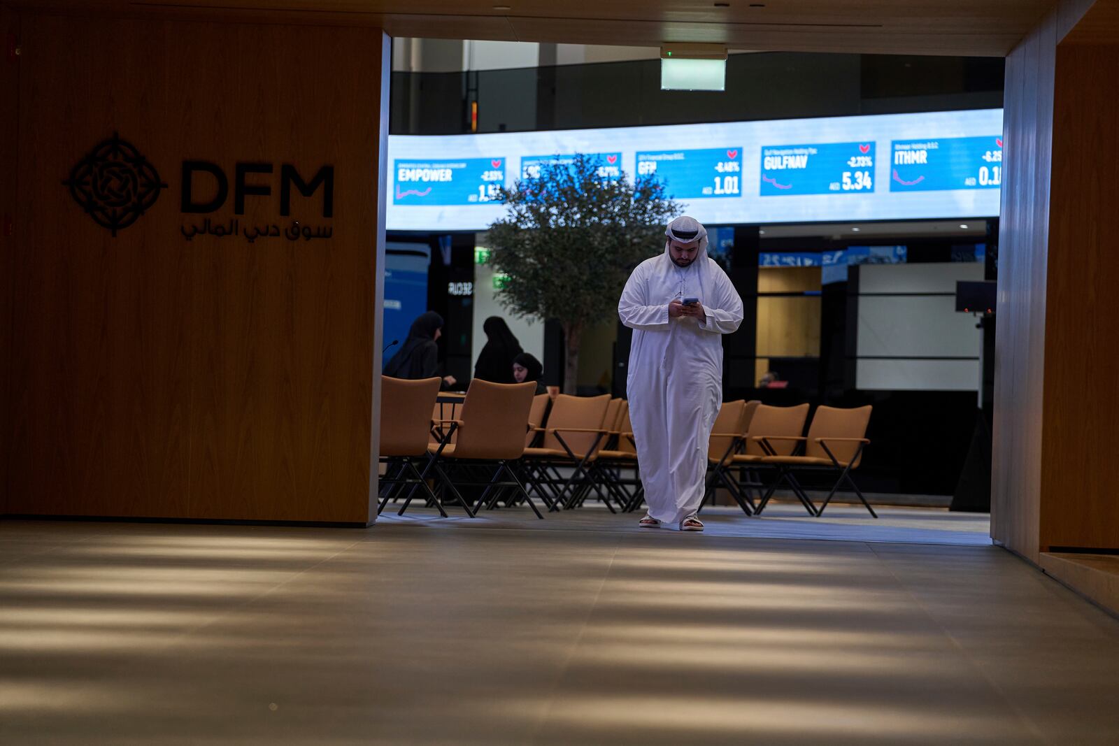 An Emirati walks out of the Dubai Financial Market in Dubai, United Arab Emirates, Monday, April 7, 2025. (AP Photos/Fatima Shbair)
