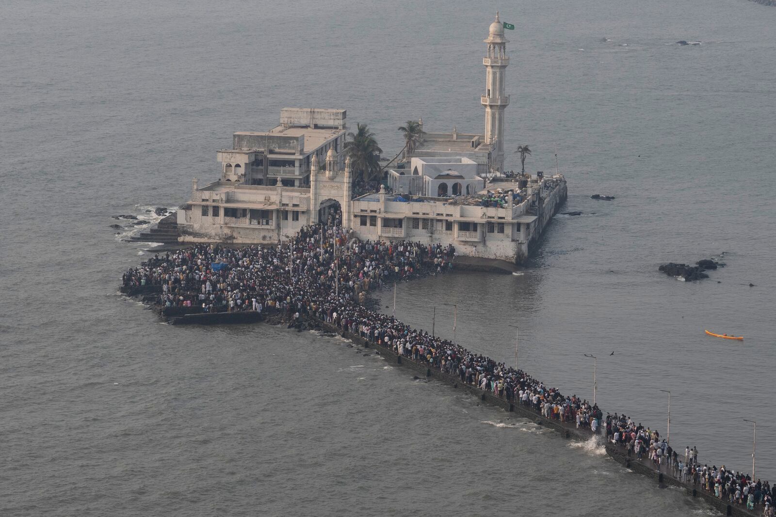 People arrive to offer prayers at Haji Ali Dargah, a Muslim shrine by the Arabian Sea coast in Mumbai, India, Wednesday, April 2, 2025. (AP Photo/Rafiq Maqbool)