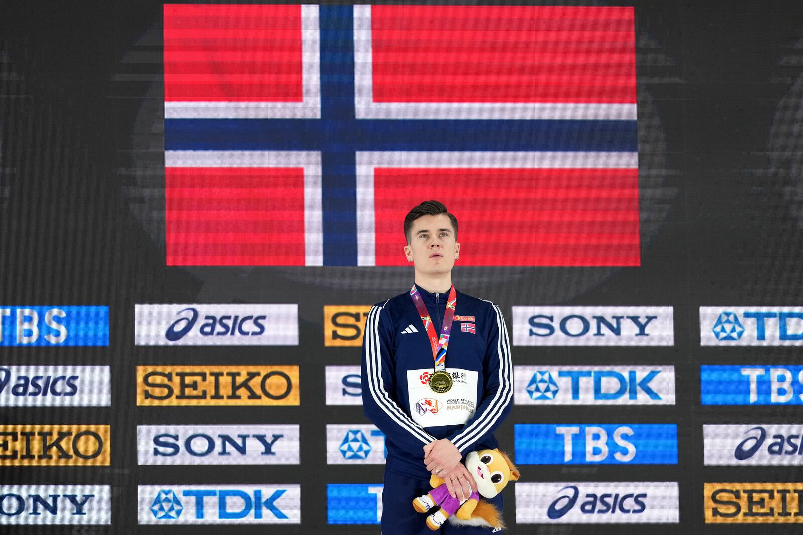 FILE - Jakob Ingebrigtsen, of Norway, stands on the podium after winning the gold medal in the men's 1500 meters at the World Athletics Indoor Championships in Nanjing, China, Sunday, March 23, 2025. (AP Photo/Vincent Thian, file)