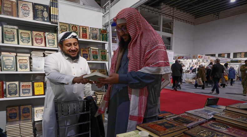 A visitor looks through a book at a stall selling Islamic titles during the 57th Damascus International Book Fair in Damascus, Syria, Monday, Feb. 16, 2026, the first edition since the collapse of the Assad regime. (AP Photo/Omar Sanadiki)