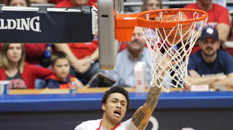 Dayton’s Kyle Davis runs into La Salle’s Cleon Roberts and is called for a charge on Saturday, Jan. 30, 2016, at UD Arena. David Jablonski/Staff
