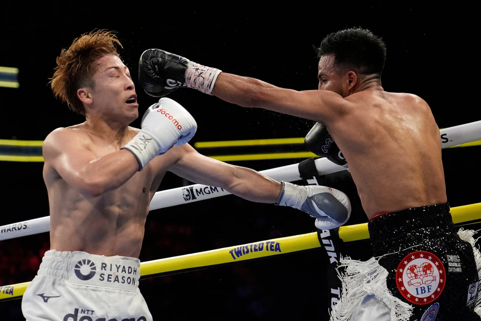Ramon Cardenas hits Naoya Inoue in a junior featherweight title boxing match Sunday, May 4, 2025, in Las Vegas. (AP Photo/John Locher)