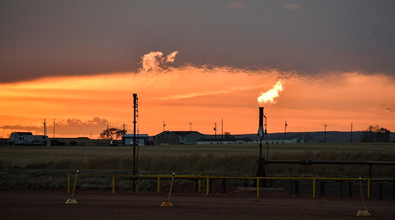 Flares burn natural gas from oil production in the Fort Berthold Indian Reservation east of New Town, North Dakota, May 18, 2021. (AP Photo/Matthew Brown, File)