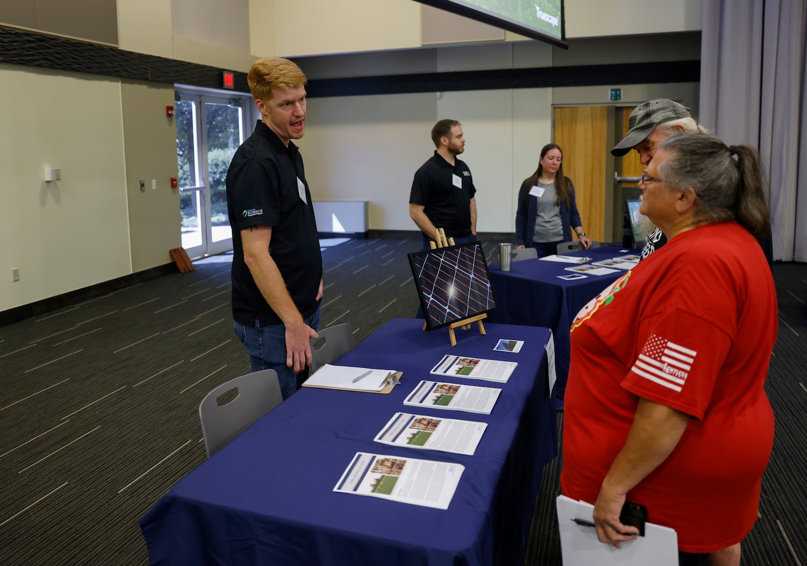 Jonathan Libbon, cultural resources director of SWCA Environmental Consultants, talks to Mary and Terry Adkins during a public information meeting held by Invenergy on Tuesday, July 8, 2025, at Hollenebeck Center to get feedback on the 180-megawatt Sloopy Solar Energy Center. JOSEPH COOKE/STAFF
