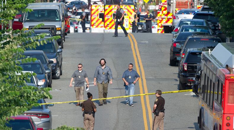 Police and emergency personnel are seen near the scene where House Majority Whip Steve Scalise of La. was shot during a Congressional baseball practice in Alexandria, Va., Wednesday, June 14, 2017.  (AP Photo/Cliff Owen)