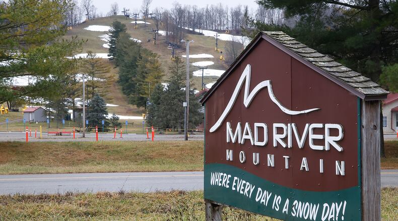 The sign outside Logan County's Mad River Mountain reads "Where Every Day is a Snow Day!" Tuesday, Dec. 26, 2023. With temperatures in the mid 50s Tuesday, there was no "Snow Day" at the ski resort. BILL LACKEY/STAFF