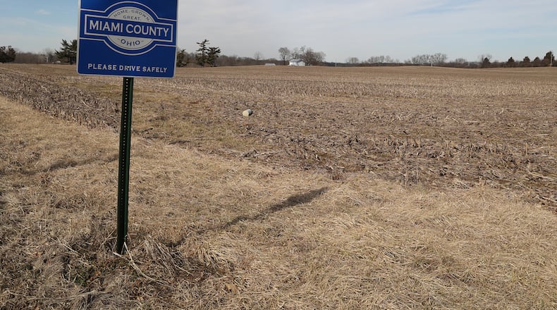 A Miami County farm field at the intersection of Scarff Road and New Carlisle Road where a proposed housing development would be located. BILL LACKEY/STAFF