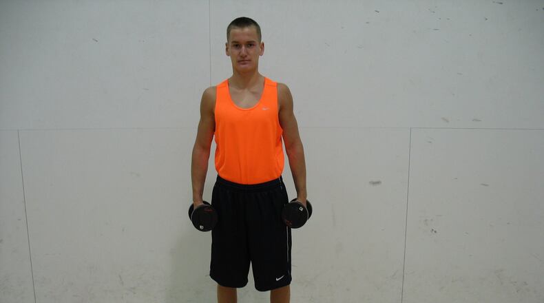 To complete a lateral arm raise, first grasp dumbbells, arms at sides. CONTRIBUTED