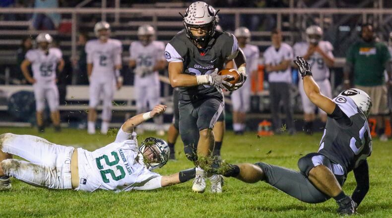 Greenon High School's Kameron Cox runs past a Madison Plains defender during their game last season. Cox was a D-V All-Ohio Honorable Mention selection last fall. CONTRIBUTED PHOTO BY MICHAEL COOPER