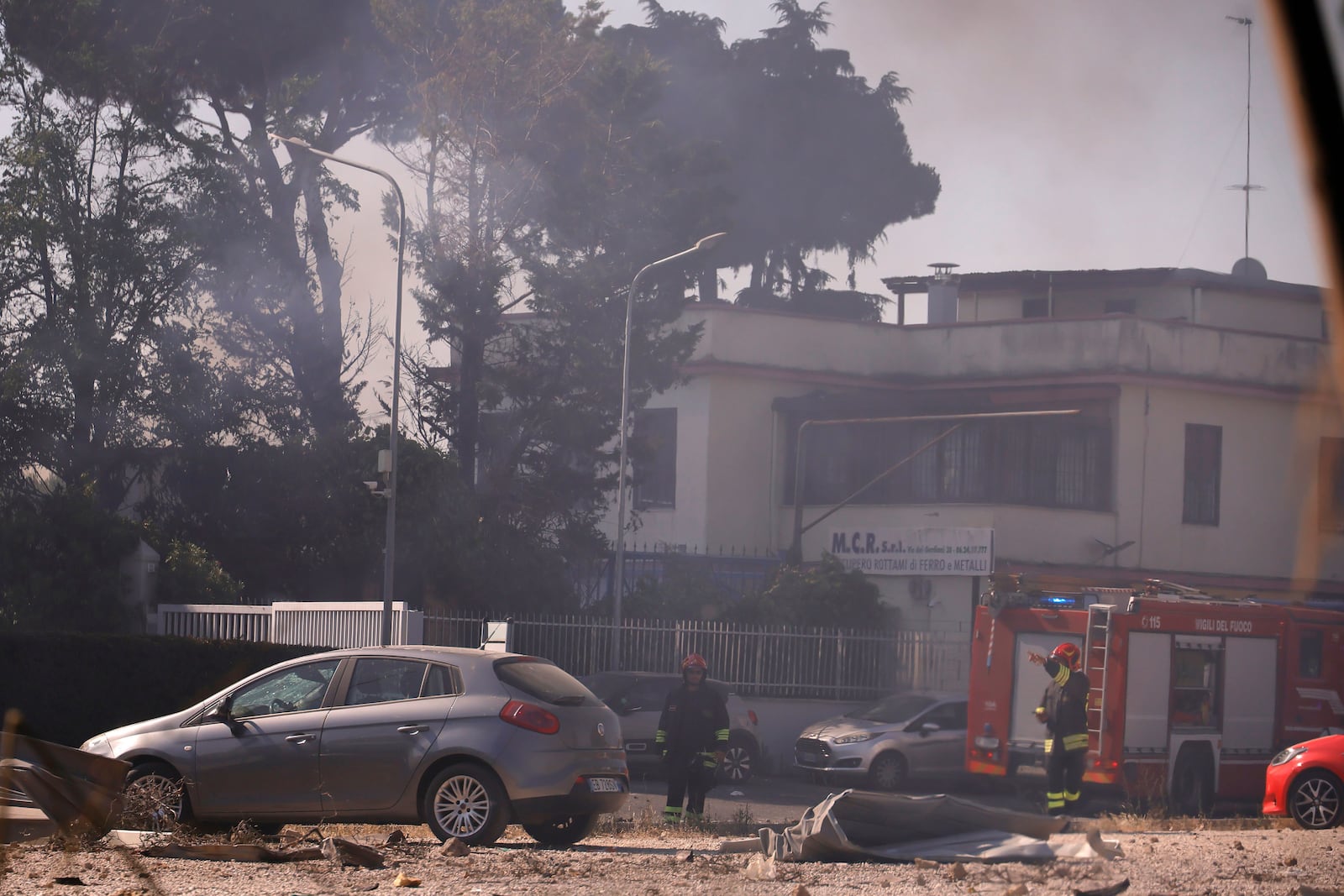 Firefighters work as smoke rises after a gas station exploded on the outskirts of Rome, Friday, July 4, 2025. (Cecilia Fabiano/LaPresse via AP)