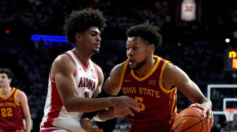 Iowa State forward Joshua Jefferson (5) drives on Arizona forward Koa Peat during the first half of an NCAA college basketball game, Monday, March 2, 2026, in Tucson, Ariz. (AP Photo/Rick Scuteri)