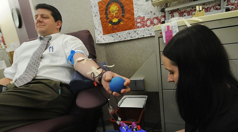 Phlebotomist Rowen Bird collects blood from donor Adam Webber at the Community Blood Center, Monday Feb. 13, 2023. Webber said he is in favor of proposed FDA changes on who can donate blood, saying it would hopefully allow more individuals to donate blood and that he didn't think there should be a stigma preventing others from donating. MARSHALL GORBY\STAFF