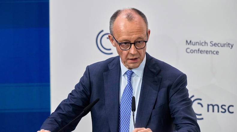 Germany's Chancellor Friedrich Merz prepares to address the audience during the Munich Security Conference in Munich, Germany, Friday, Feb. 13, 2026. (AP Photo/Michael Probst)