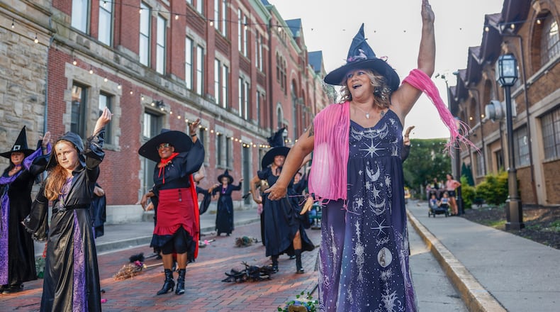 Shella Baker dances with the Rose City Witches outside Myers Market on Friday, Oct. 3, 2025, in Springfield. The performance was part of a Think Pink Foundation event to raise awareness about breast cancer. JOSEPH COOKE/STAFF