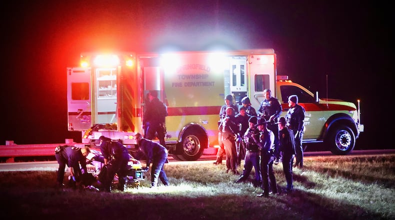 A man is placed into an ambulance after an interaction with police along U.S. 68 near Ohio 41 in Clark County on Tuesday, January 1, 2025. MARSHALL GORBY\STAFF