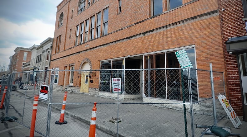 The sidewalk and street parking in front of the Tavern building on West Main Street in Troy have been closed for three years. MARSHALL GORBY / STAFF