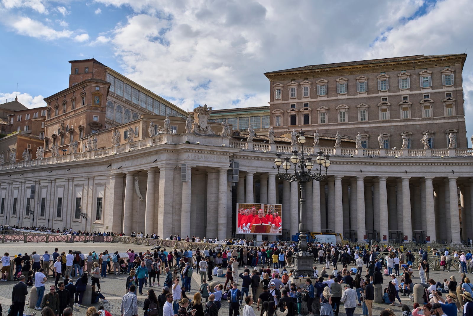 Faithful watch on a giant screen in St Peter's Square cardinals taking their oath at the start of the conclave to elect a new pope, at the Vatican, Wednesday, May 7, 2025. (AP Photo/Bernat Armangue)