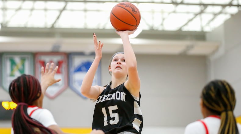 Greenon junior Abby West shoots the ball over multiple Purcell Marian defenders during their Division III district final game last year at Springfield High School. CONTRIBUTED PHOTO BY MICHAEL COOPER