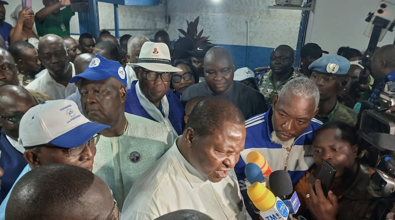 Central African Republic President Faustin Archange Touadéra, bottom center, speaks to the media after being declared the winner of the presidential election in Bangui, Central African Republic, Monday, Jan. 5, 2026. (AP Photo/Jean-Fernand Koena)