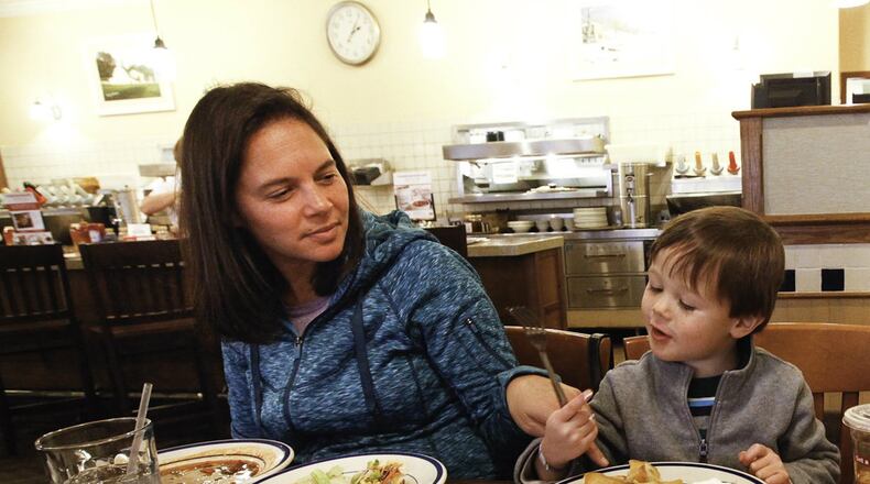 Tanya Thompson of Denver, Colo., eats with her son Ben, 3, at the Bob Evans restaurant on Dorothy Lane in Kettering in this file photo. Bob Evans will be among the eateries and retailers opting to be open for business on Thanksgiving Day. CHRIS STEWART / STAFF