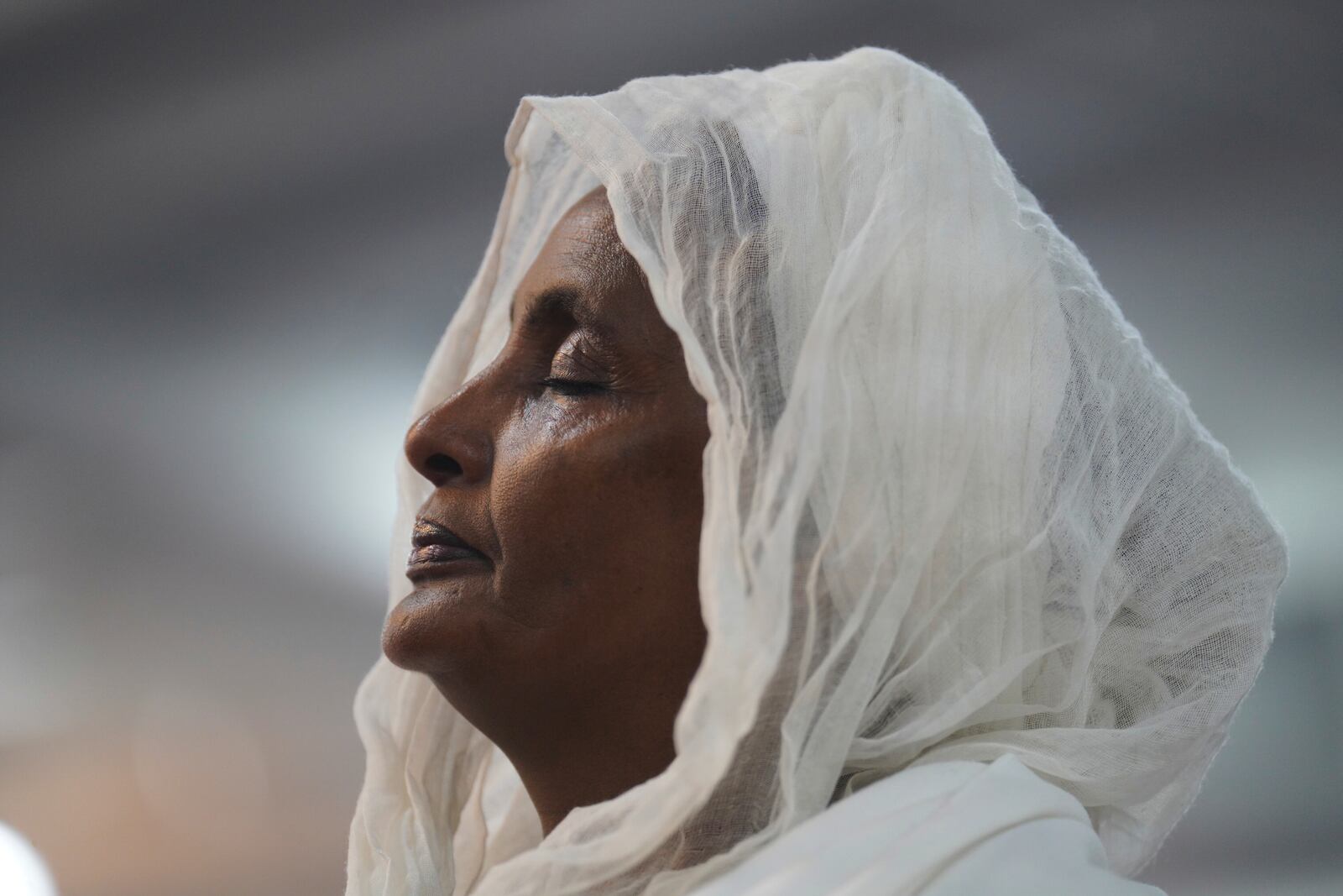 A congregant of the Re'ese Adbarat Debre Selam Kidist Mariam Church, an Ethiopian Orthodox Tewahedo church, stands during a service in Washington, D.C., Saturday, April 5, 2025. (AP Photo/Jessie Wardarski)