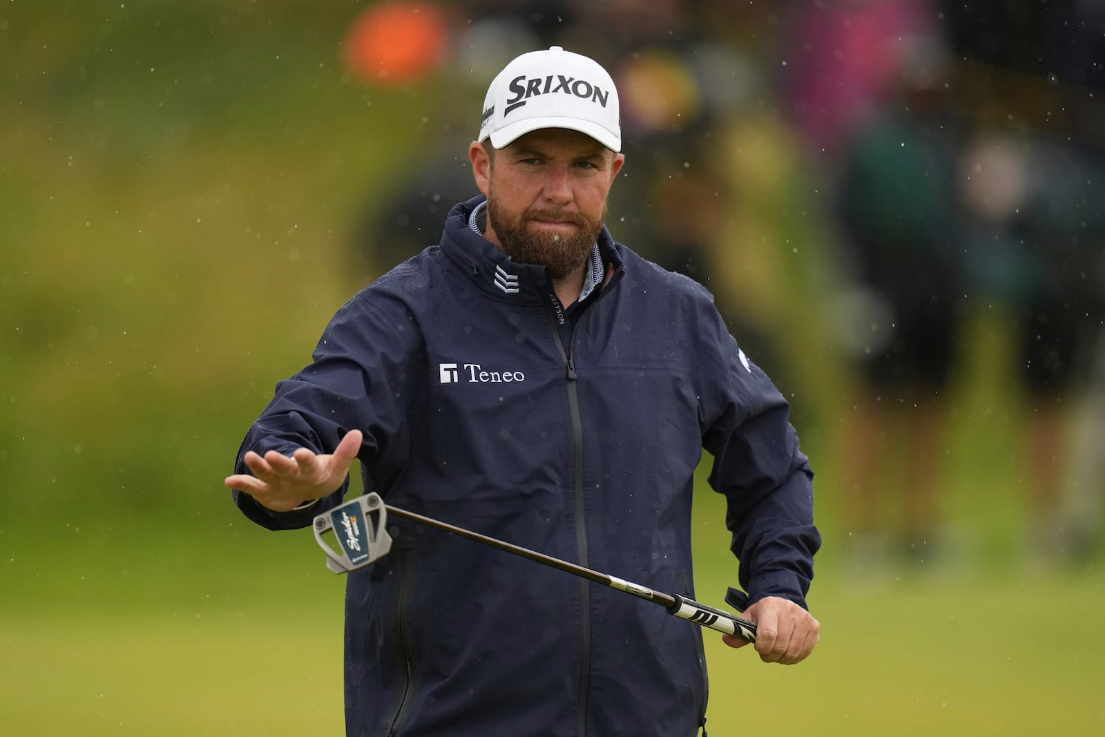Shane Lowry of Ireland wipes the head of the putter clean before playing on the 7th green during the first round of the British Open golf championship at the Royal Portrush Golf Club, Northern Ireland, Thursday, July 17, 2025. (AP Photo/Francisco Seco)