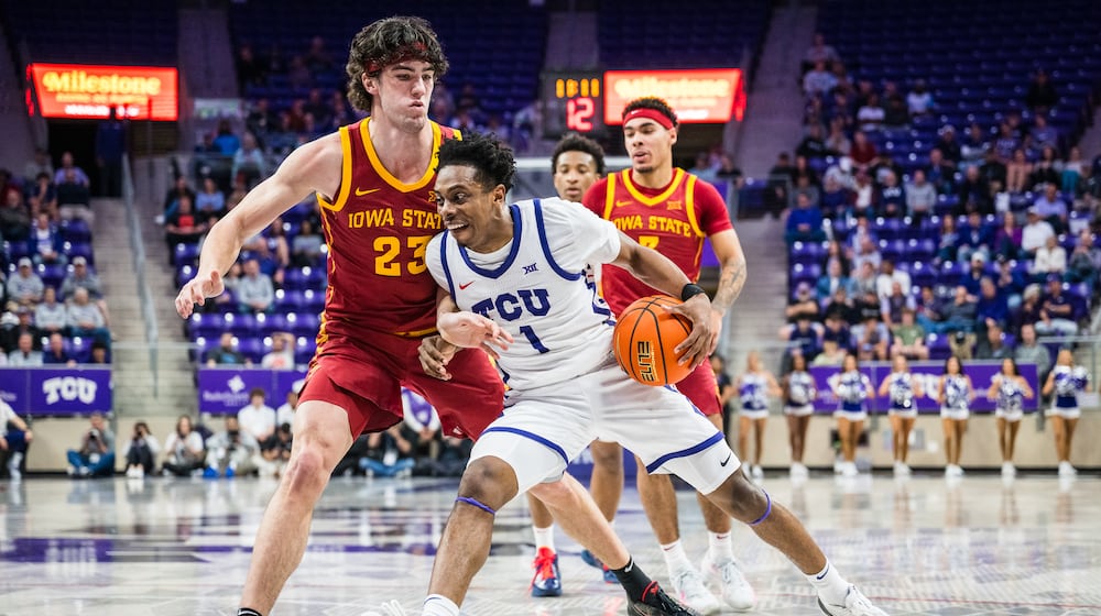 TCU guard Jayden Pierre (1) drives the ball against Iowa State forward Blake Buchanan (23) during an NCAA college basketball game, Tuesday, Feb. 10, 2026, Fort Worth, Texas. (AP Photo/Jessica Tobias)