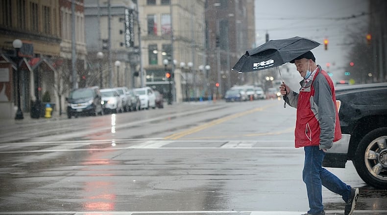 Good day to have an umbrella when you’re walking across Third Street, Tuesday February 22, 2022.