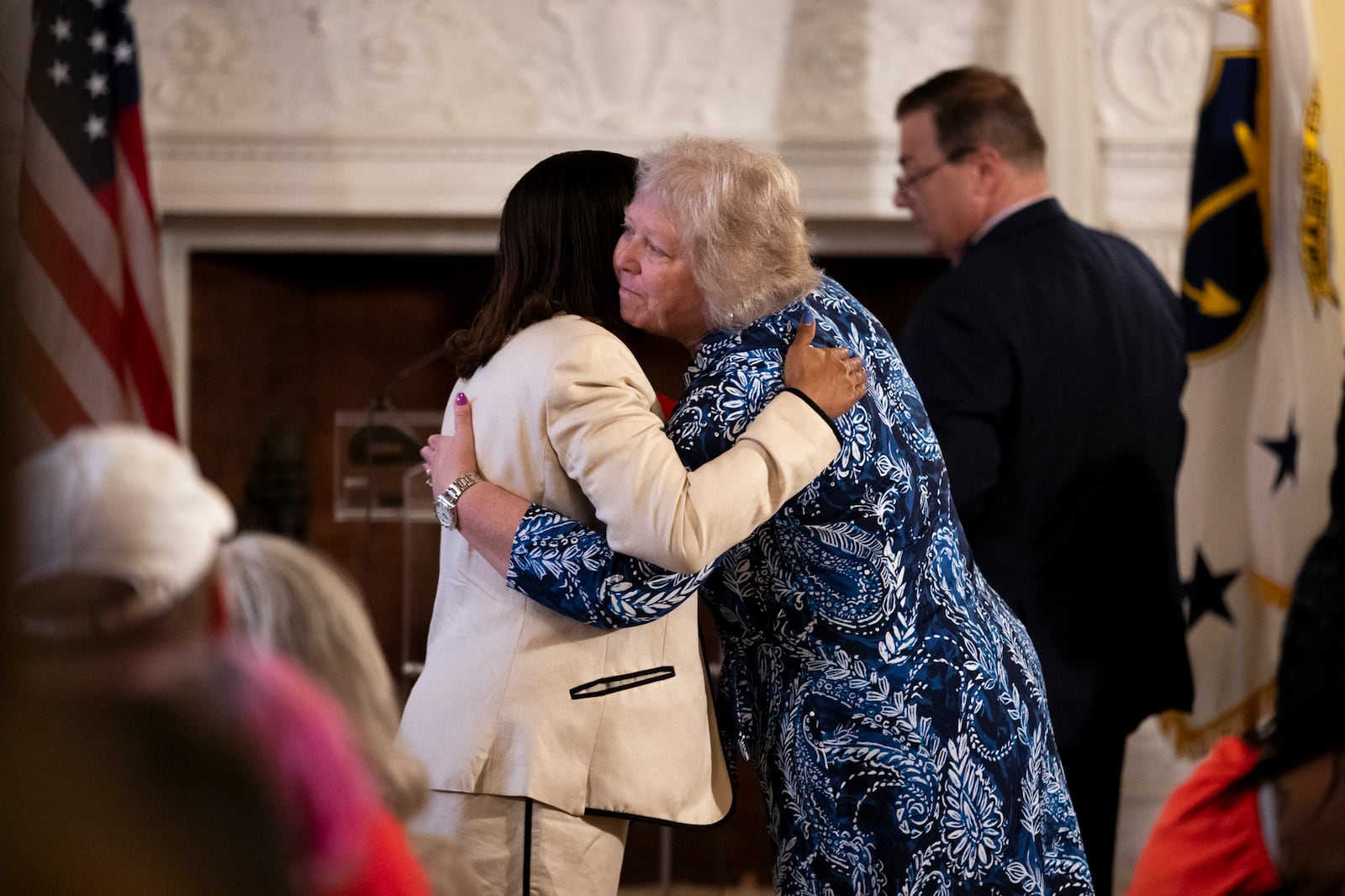 President of the Rhode Island Senate, Senator Valarie J. Lawson, right, hugs Rhode Island Lt. Gov. Sabina Matos before Governor Dan McKee signs a bill banning the sale of assault-style weapons in the state of Rhode Island at the Rhode Island Statehouse in Providence, Thursday, June 26, 2025. (AP Photo/Sydney Roth)