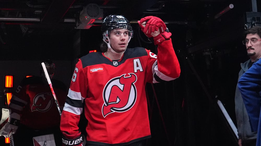 New Jersey Devils' Jack Hughes (86) walks toward the ice to warm up before an NHL hockey game against the Buffalo Sabres Wednesday, Feb. 25, 2026, in Newark, N.J. (AP Photo/Frank Franklin II)