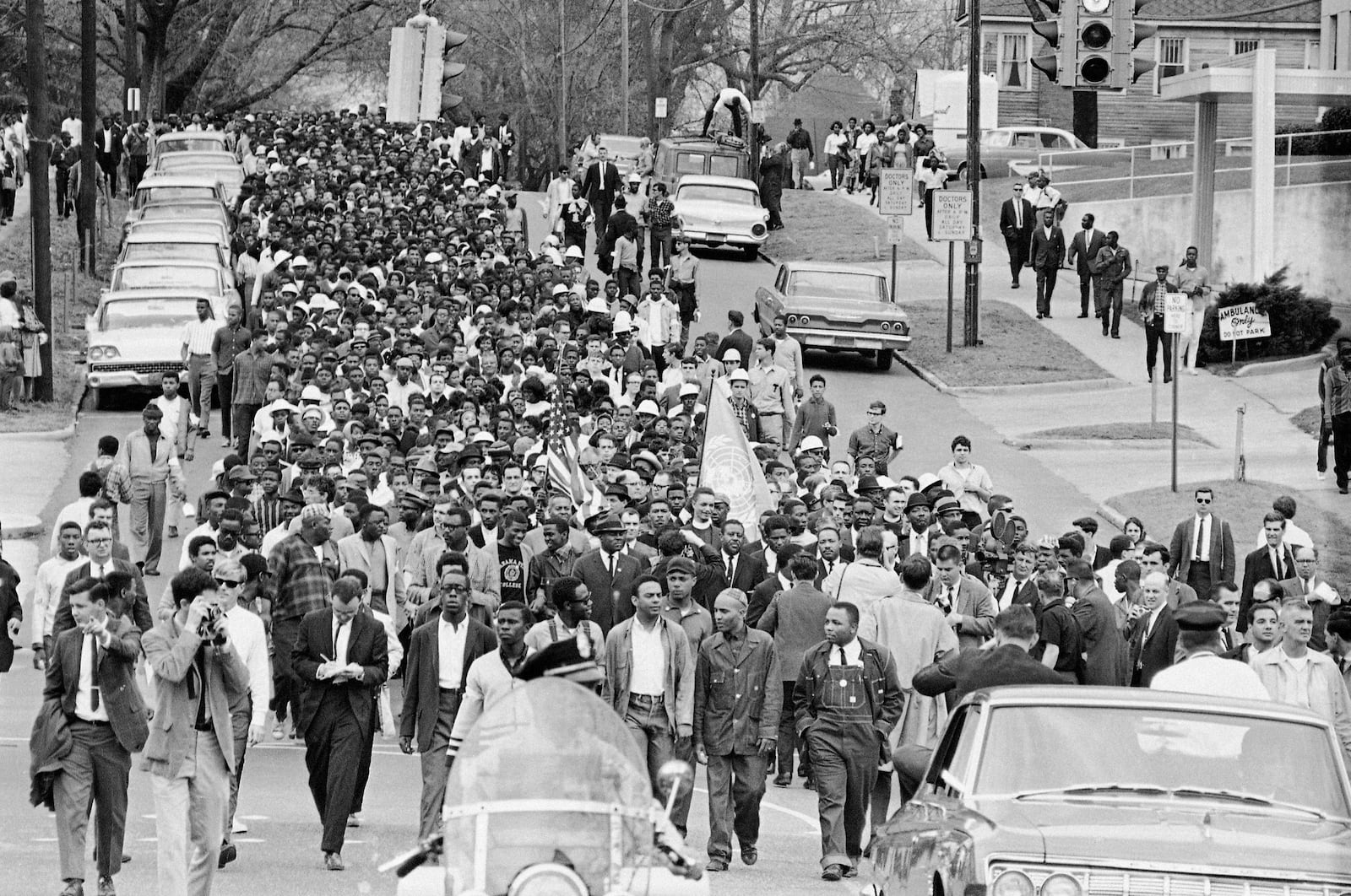 FILE - Demonstrators walk to the courthouse behind the Rev. Martin Luther King Jr. in Montgomery, Ala., March 17, 1965, to protest treatment of demonstrators by police during an attempted march. (AP Photo/File)